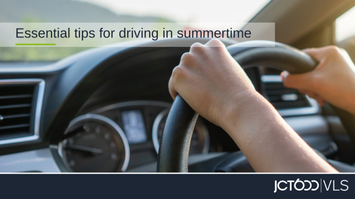 Close up of person driving with text overlay reading Tips for driving in summertime